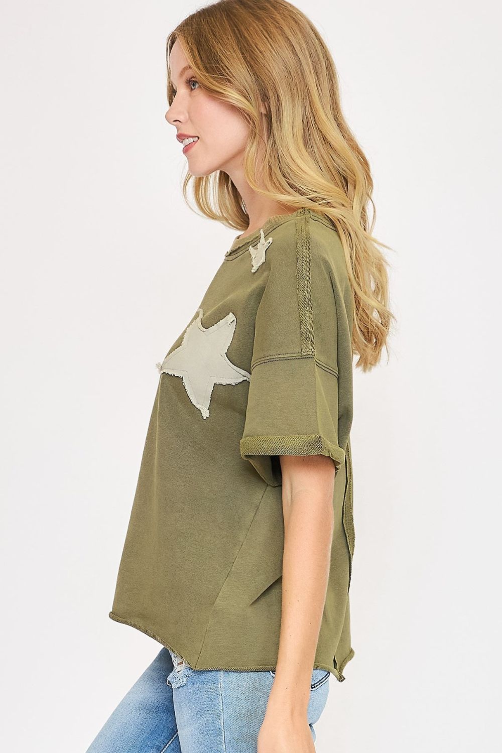 Trendy star-patched French terry top with a mineral-washed finish, offering a cozy and playful casual style.