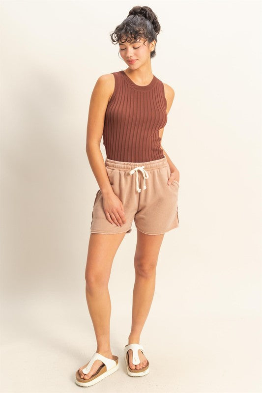 Stretchy ribbed round neck sweater tank in a sleek, versatile design for effortless styling.