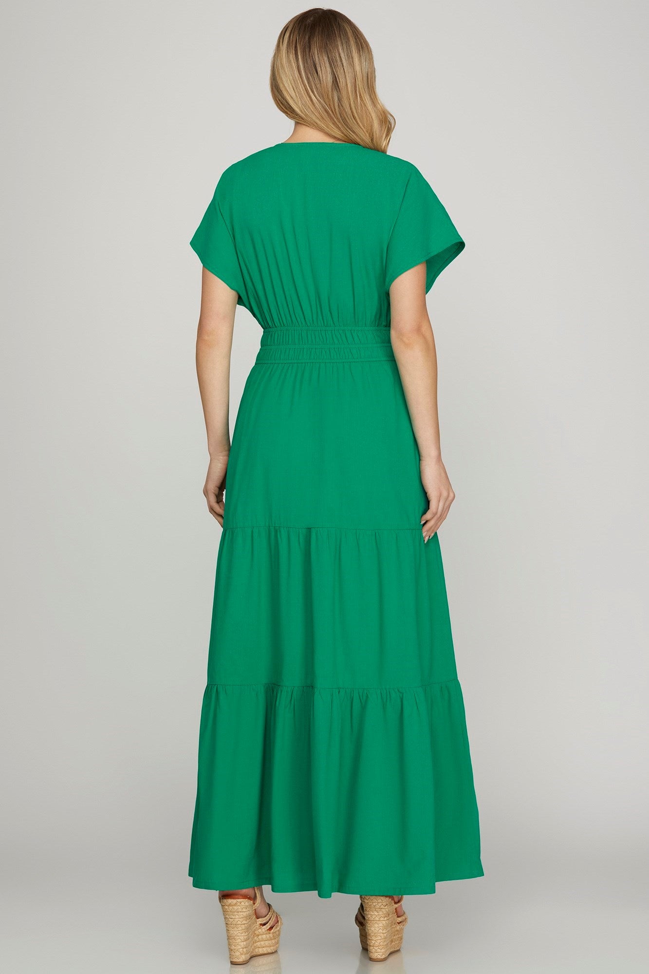 Elegant surplice short sleeve tiered maxi dress with pockets, perfect for casual and formal occasions.