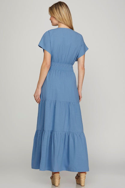 Elegant surplice short sleeve tiered maxi dress with pockets, featuring a flowing silhouette for effortless style.