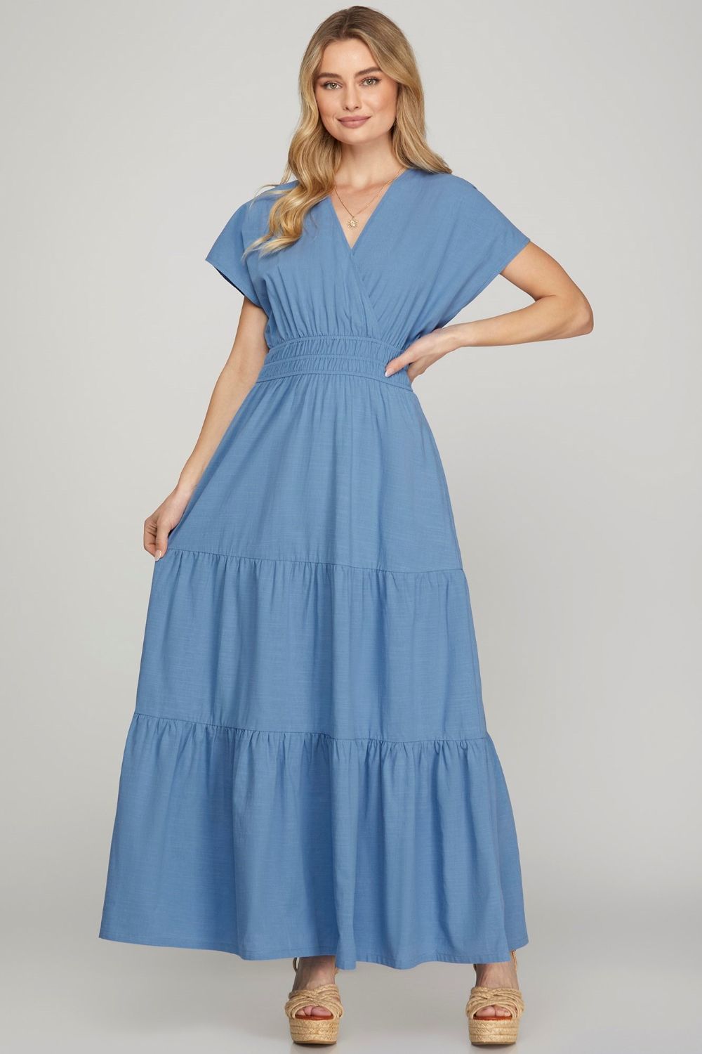 Elegant surplice short sleeve tiered maxi dress with pockets, featuring a flowing silhouette for effortless style.