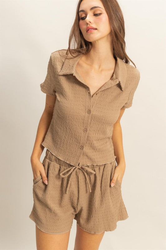 Cozy textured knit two-piece set with a short sleeve top and adjustable drawstring shorts, perfect for lounging or casual wear.