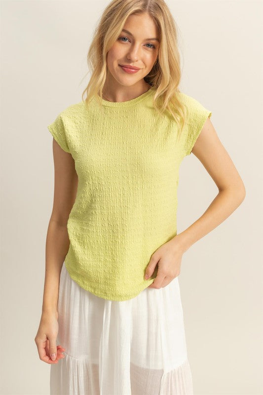 Textured round neck cap sleeve knit top with a classic and versatile design, perfect for casual and dressy outfits.