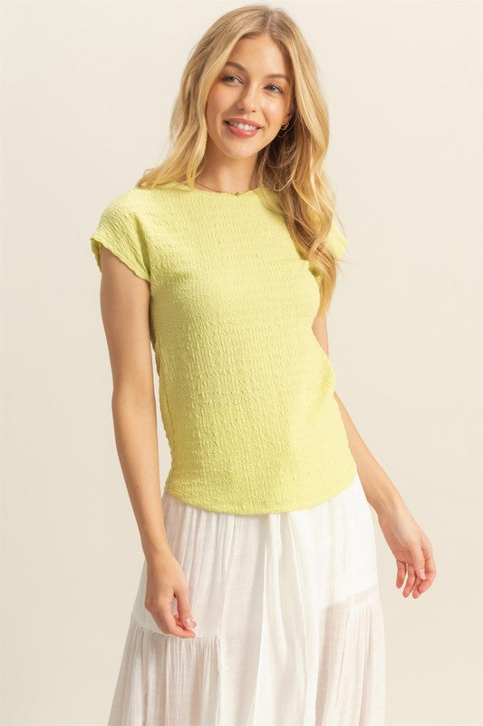 Textured round neck cap sleeve knit top with a classic and versatile design, perfect for casual and dressy outfits.