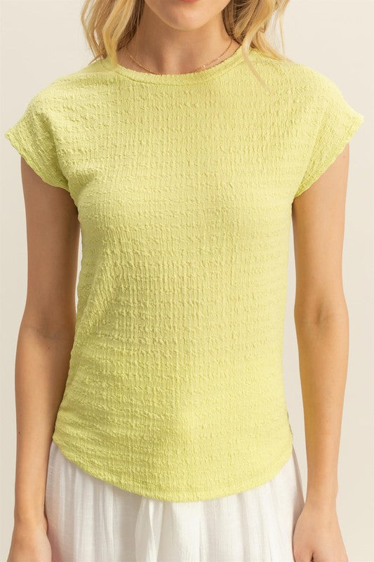 Textured round neck cap sleeve knit top with a classic and versatile design, perfect for casual and dressy outfits.