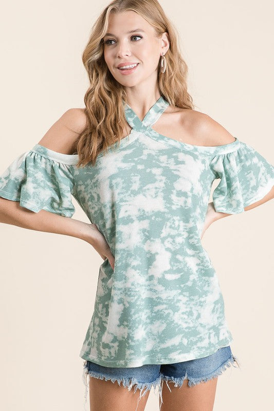 Trendy tie-dye open shoulder ruffled short sleeve top featuring a vibrant print, feminine ruffles, and a stylish shoulder cutout.