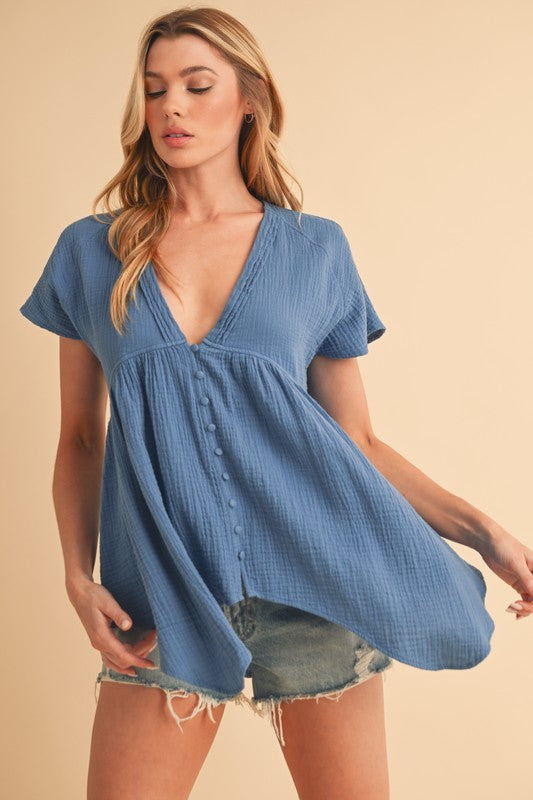 Chic tuck detail V-neck short sleeve blouse in breathable cotton, perfect for both professional and casual styling.