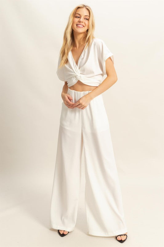 Stylish twisted front short sleeve top & high-waisted wide leg pants set, designed for a modern & effortlessly chic look.