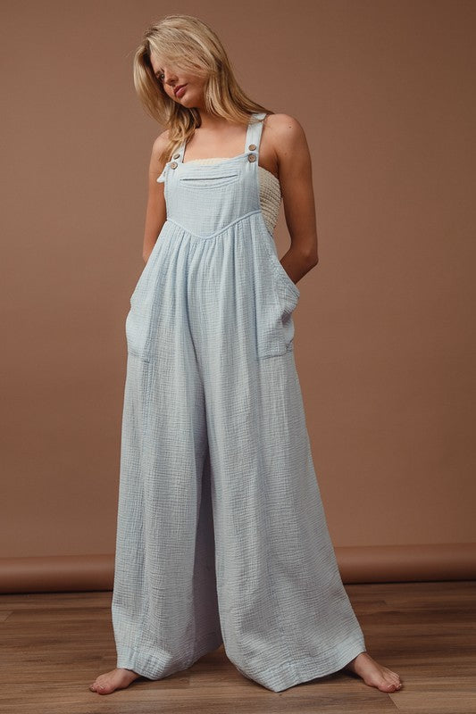 Vintage washed crinkle gauze wide-leg overalls with adjustable straps and side pockets for a relaxed, trendy look.