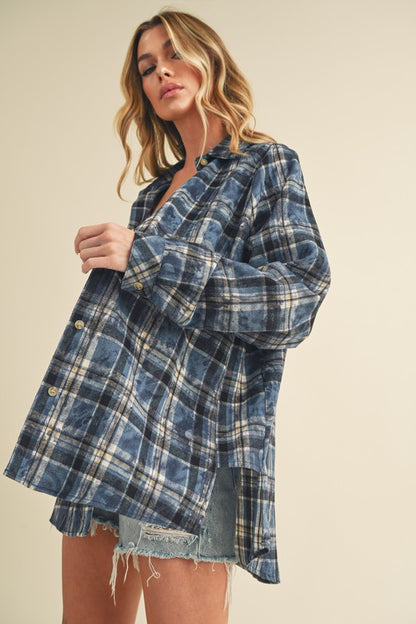 Soft washed plaid flannel shirt with a button-up front and unique side step hem, perfect for casual and stylish looks.