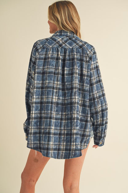 Soft washed plaid flannel shirt with a button-up front and unique side step hem, perfect for casual and stylish looks.